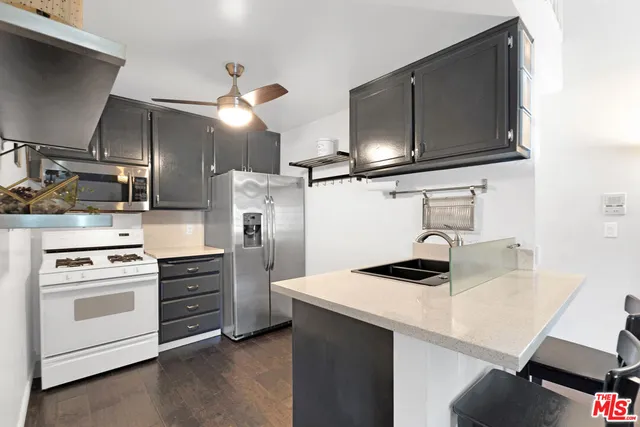 a kitchen with stainless steel appliances a sink stove and refrigerator