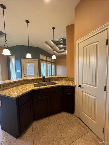 a bathroom with a granite countertop sink a vanity and a large mirror