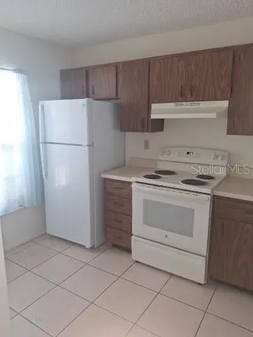 a kitchen with a stove cabinets and refrigerator