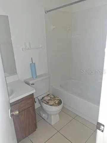 a bathroom with a sink a toilet and bathtub