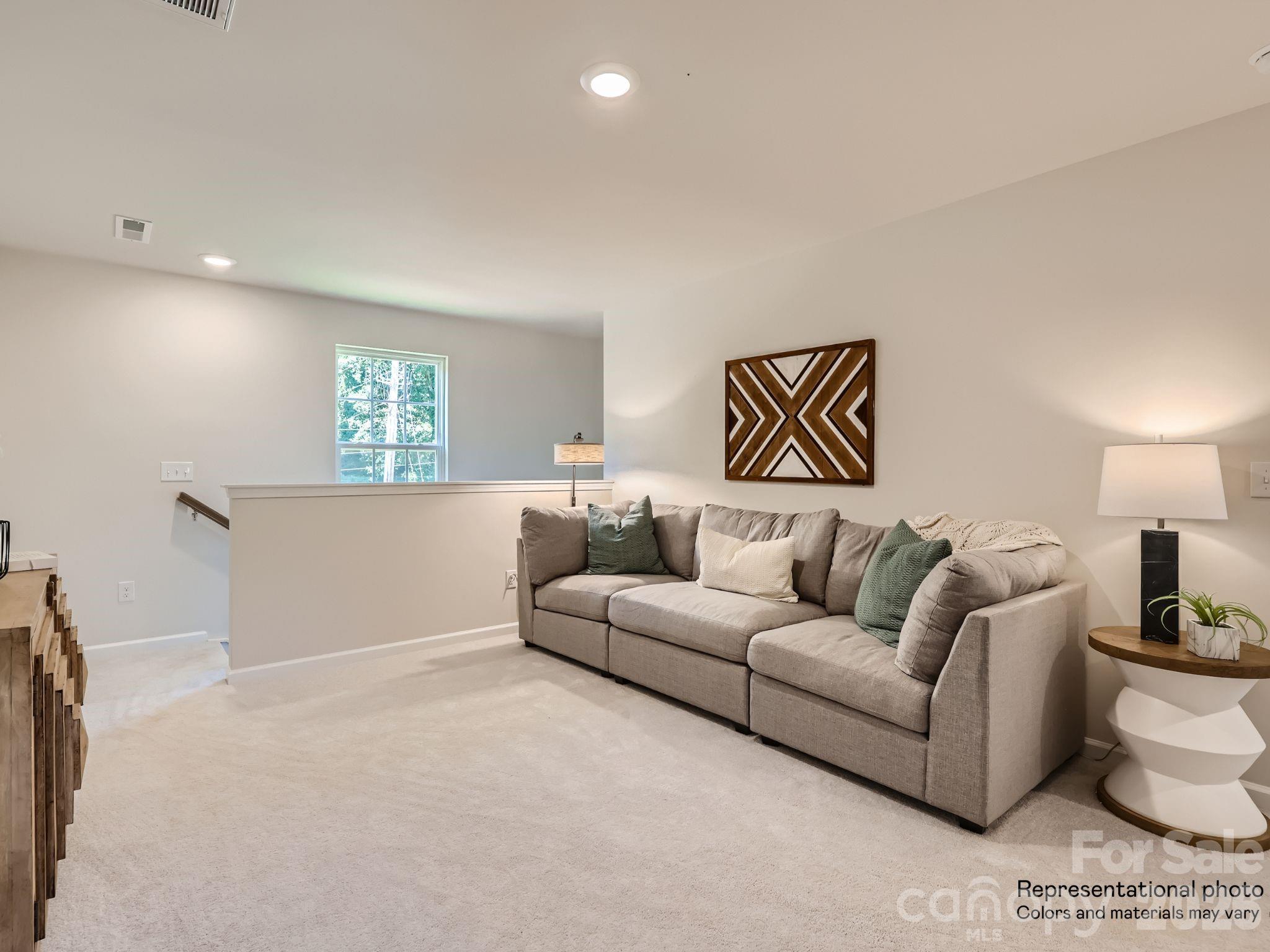 143 Spotted Way Troutman, NC 28166 - Photo 14 of 24 a living room with furniture and a couch