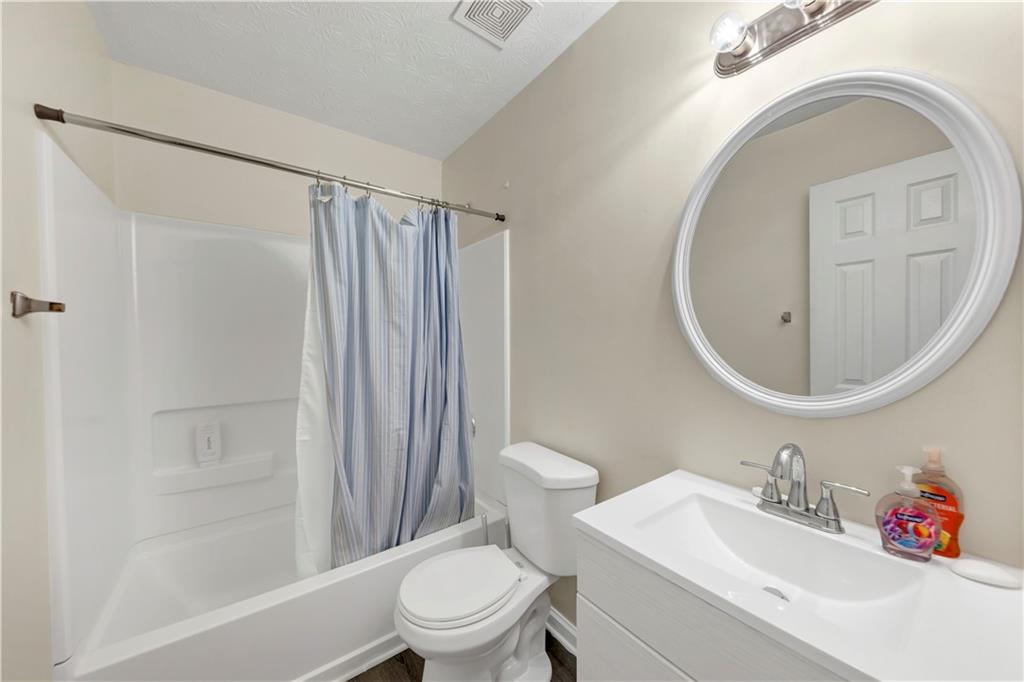 2880 Field Spring Drive Lithonia, GA 30058 - Photo 22 of 31 a white toilet sitting next to a bathroom sink