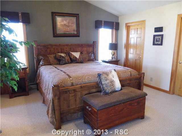 1450 Buck Road Calhan, CO 80808 - Photo 5 of 25 The large master bedroom with walk in closet, vaulted ceilings, adjacent master bath and access to lanai. Holds a king size bed with lots of room to spare.