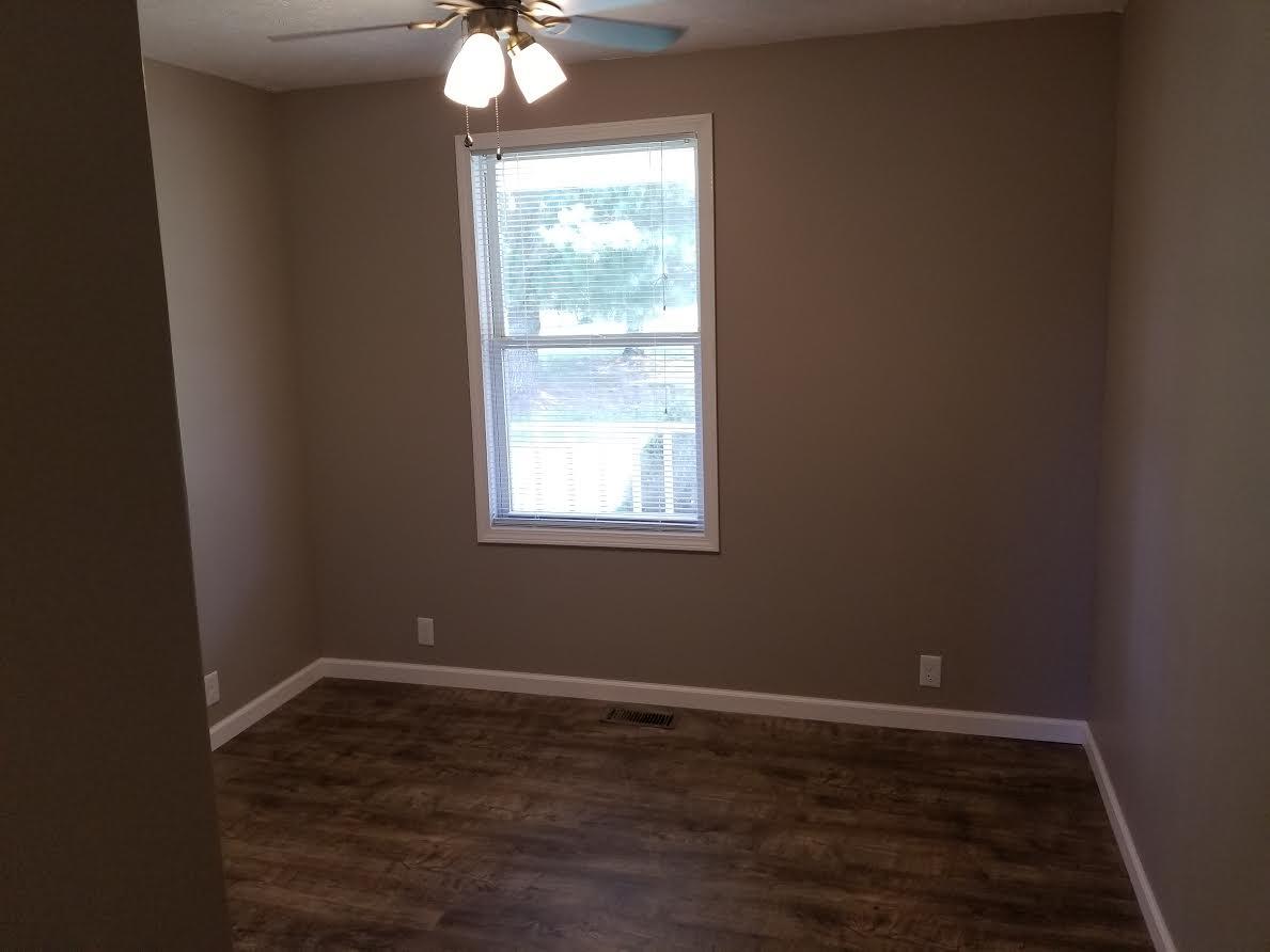 290 Tom Ferrell Road Portland, TN 37148 - Photo 11 of 14 an empty room with wooden floor and windows