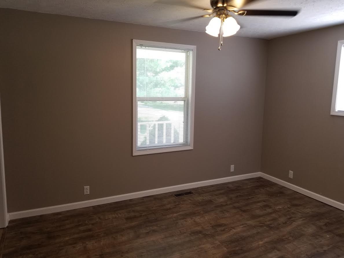 290 Tom Ferrell Road Portland, TN 37148 - Photo 12 of 14 a view of wooden floor and chandelier fan in a room