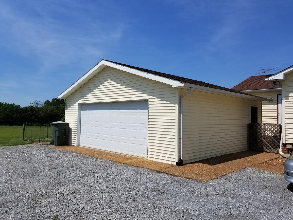 290 Tom Ferrell Road Portland, TN 37148 - Photo 3 of 14 a front view of a house with a yard and garage