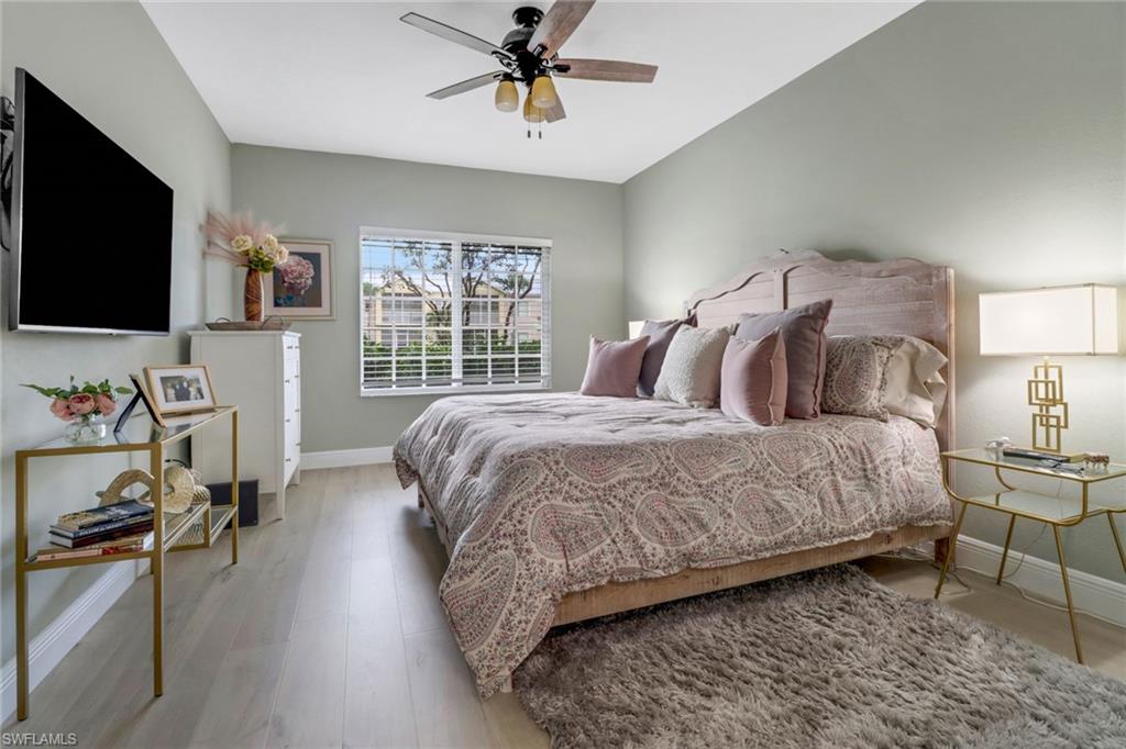 20261 Estero Gardens Circle, Unit 104 Estero, FL 33928 - Photo 14 of 50 Bedroom featuring light hardwood / wood-style floors and ceiling fan
