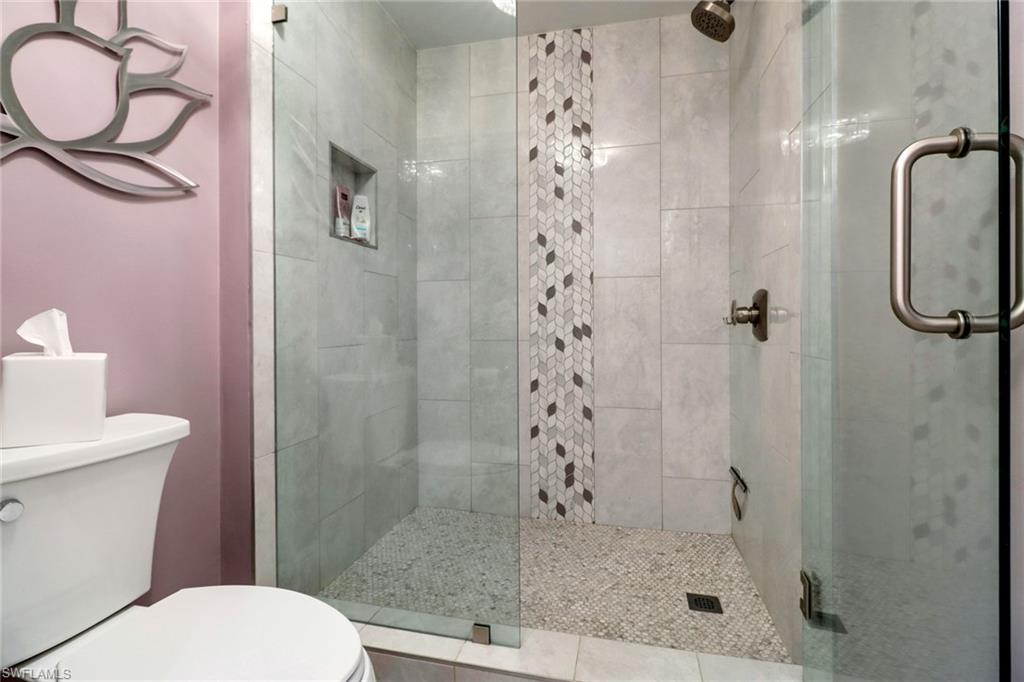 20261 Estero Gardens Circle, Unit 104 Estero, FL 33928 - Photo 17 of 50 Bathroom featuring an enclosed shower and toilet