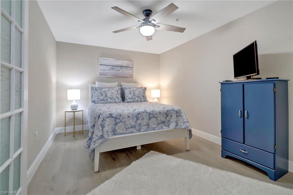 20261 Estero Gardens Circle, Unit 104 Estero, FL 33928 - Photo 18 of 50 Bedroom with ceiling fan and wood-type flooring