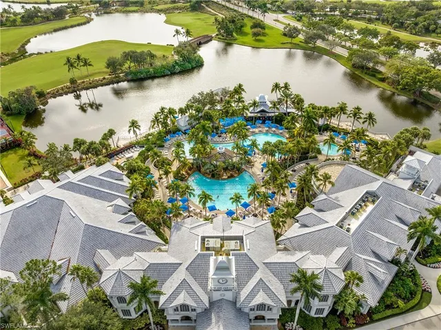 an aerial view of residential houses with outdoor space and lake view