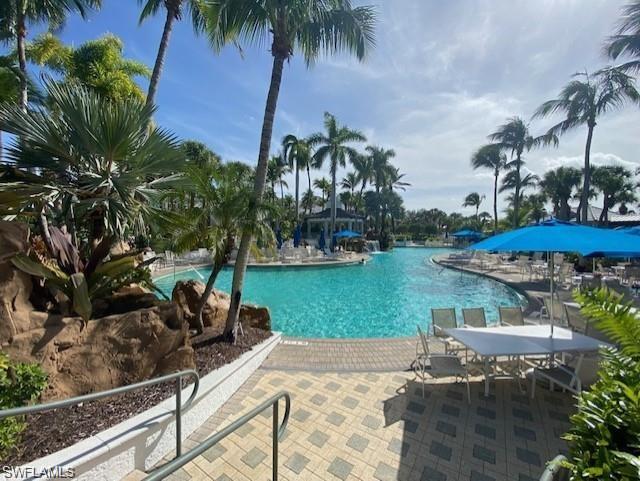 9259 Museo Circle, Unit 7102 Naples, FL 34114 - Photo 24 of 41 a backyard of a house with a garden and outdoor seating