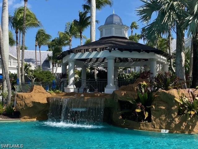 9259 Museo Circle, Unit 7102 Naples, FL 34114 - Photo 25 of 41 a view of a chairs and tables in the patio and a fountain in yard