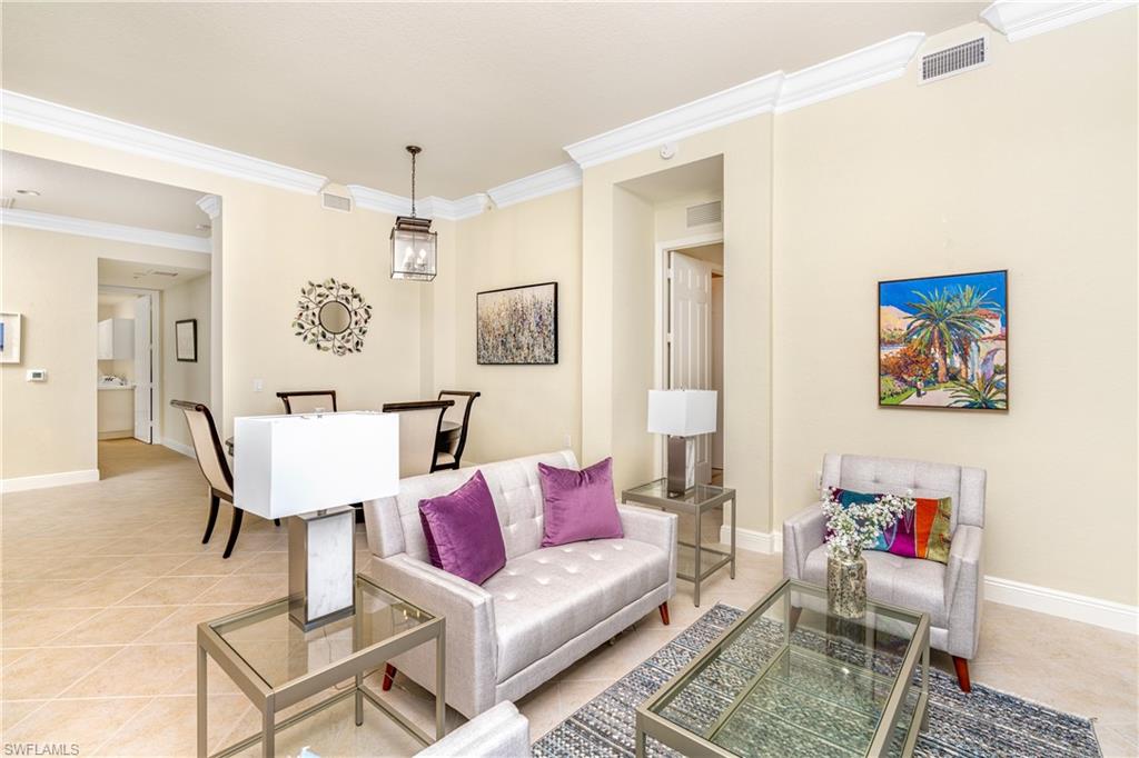 9259 Museo Circle, Unit 7102 Naples, FL 34114 - Photo 3 of 41 a living room with furniture or couch and a painting on the wall