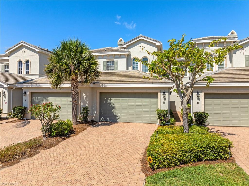 9259 Museo Circle, Unit 7102 Naples, FL 34114 - Photo 38 of 41 a front view of a house with a yard