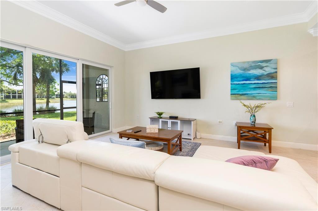 9259 Museo Circle, Unit 7102 Naples, FL 34114 - Photo 10 of 41 a bedroom with a bed and a flat screen tv