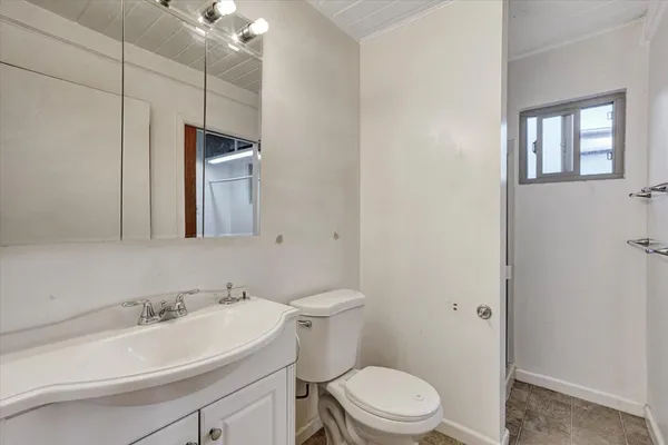 a bathroom with a sink a toilet and mirror