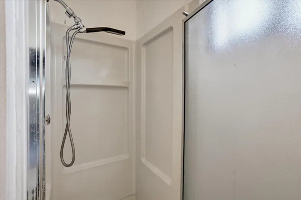 a bathroom with a glass shower door