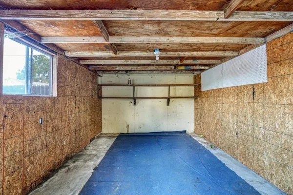 a view of a room with wooden walls and window