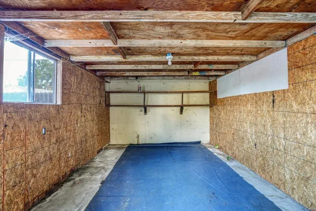 a view of a room with wooden walls and window