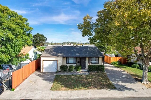a front view of a house with a garden