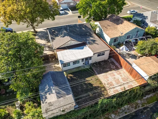 an aerial view of a house with a yard