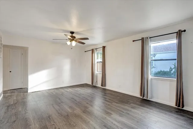 wooden floor in an empty room with a window