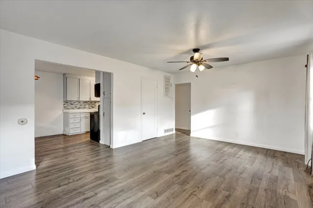 a view of an empty room with a kitchen