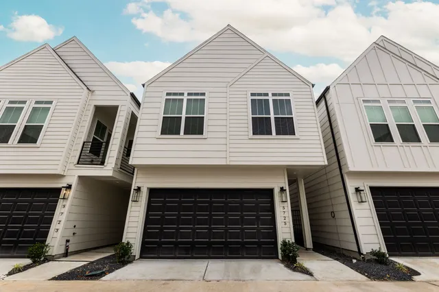 a front view of a house with many windows