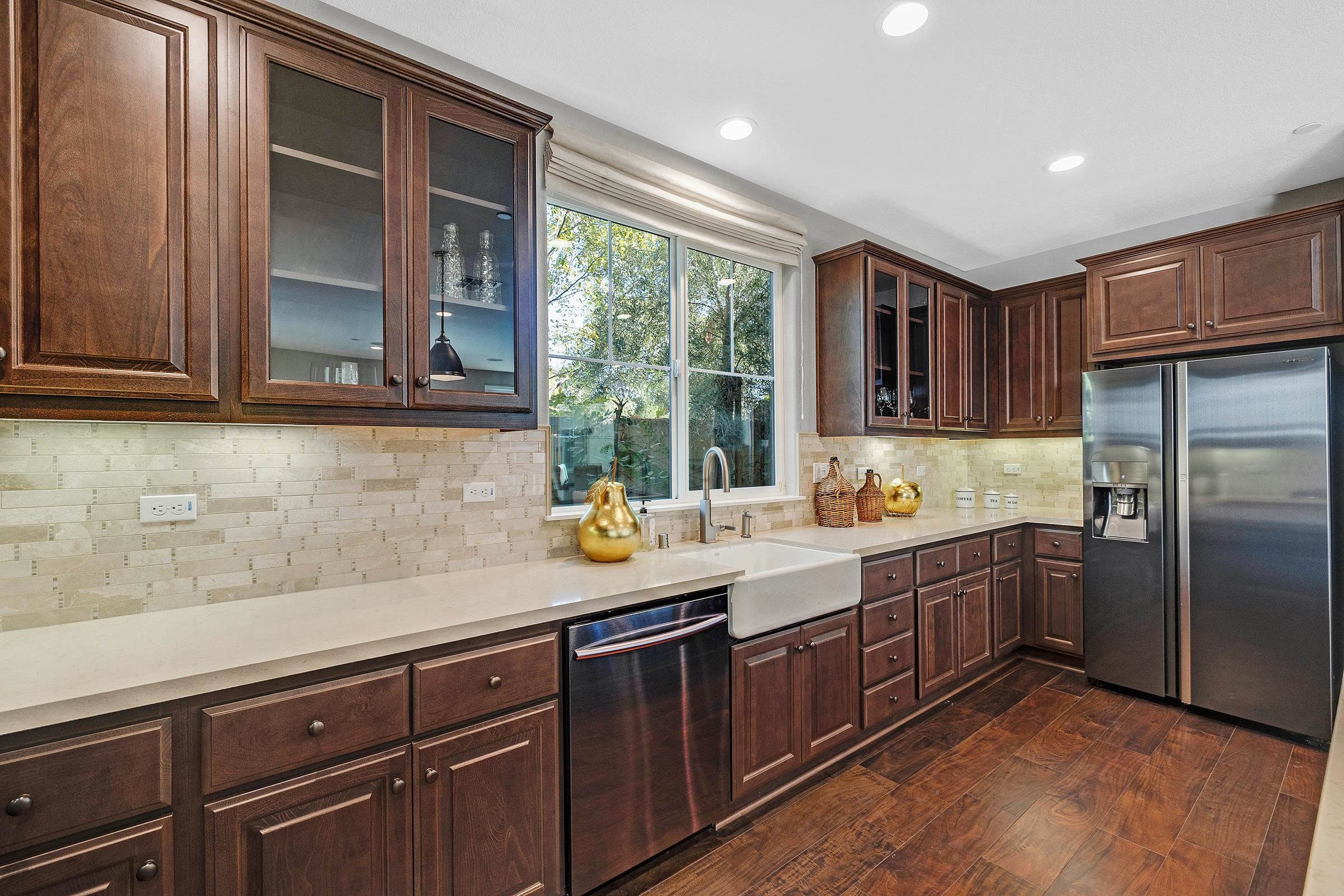 883 Barney Common Livermore, CA 94551 - Photo 13 of 38 a kitchen with a sink window and cabinets