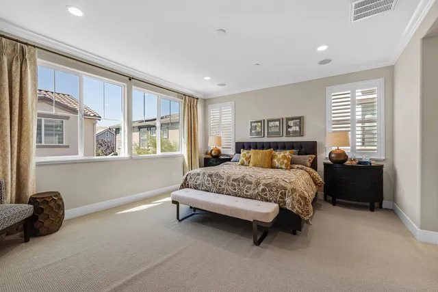 a bedroom with a bed and a lamp