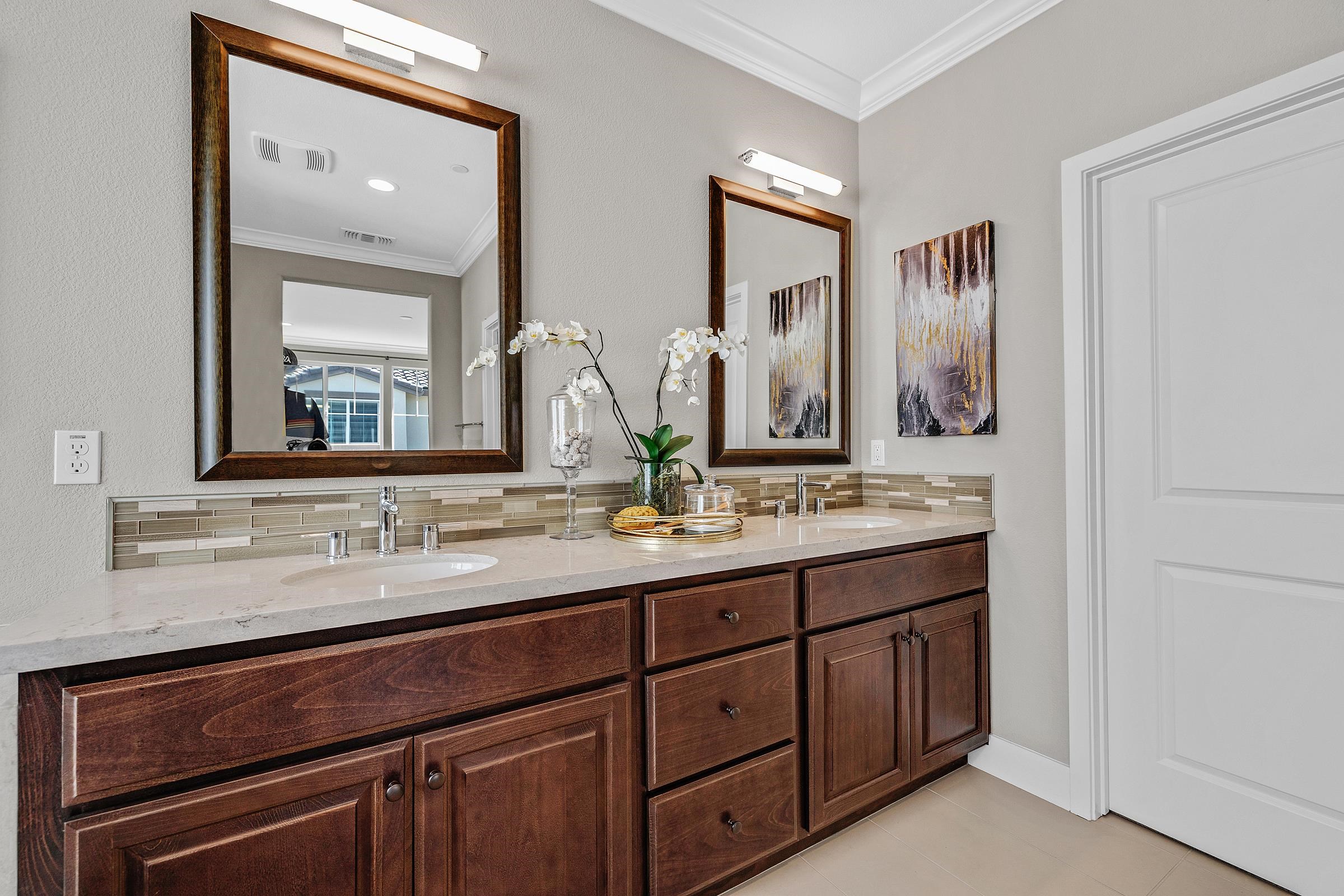 883 Barney Common Livermore, CA 94551 - Photo 27 of 38 a bathroom with a double vanity sink and a mirror