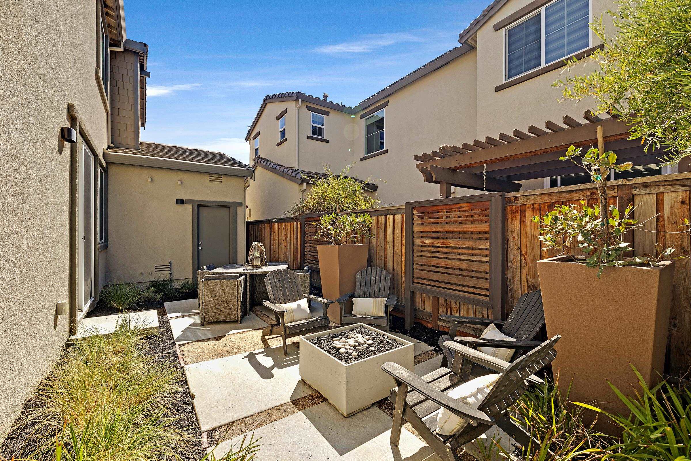 883 Barney Common Livermore, CA 94551 - Photo 36 of 38 a backyard of a house with fire pit and outdoor seating