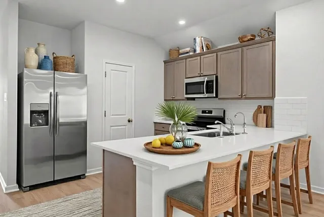 a kitchen with a refrigerator and microwave