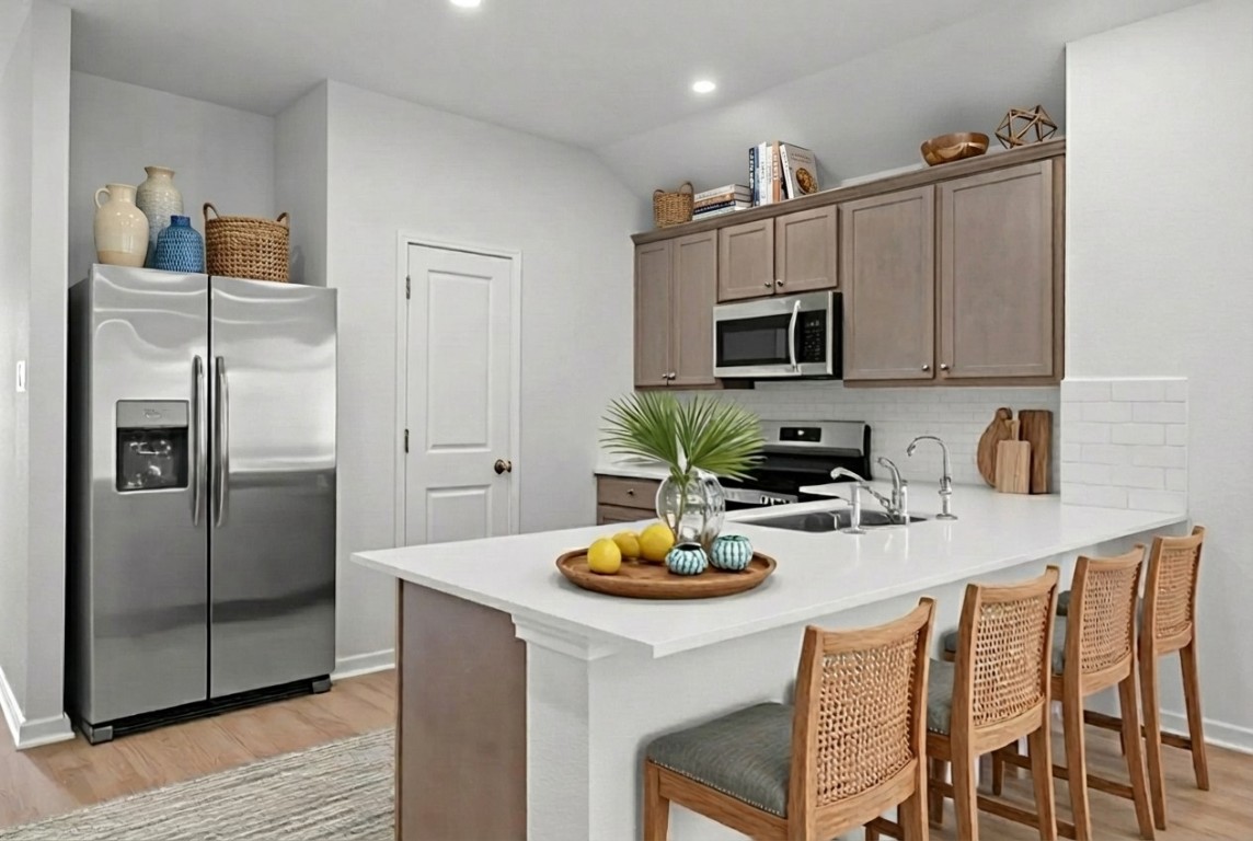 129 Hatari Trail Jarrell, TX 76537 - Photo 2 of 33 a kitchen with a refrigerator and microwave