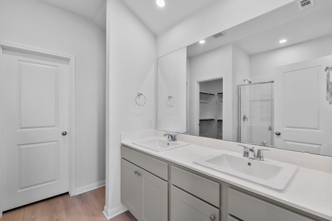 129 Hatari Trail Jarrell, TX 76537 - Photo 25 of 33 a bathroom with a sink and a mirror