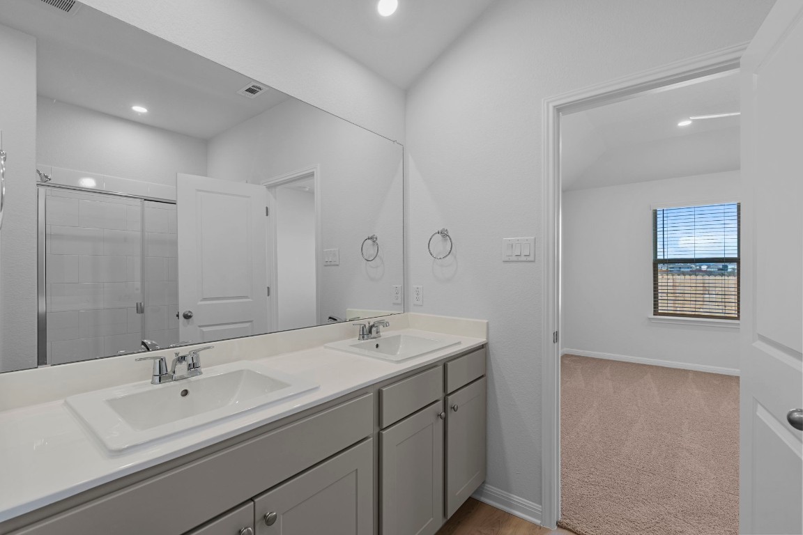 129 Hatari Trail Jarrell, TX 76537 - Photo 26 of 33 a bathroom with a sink and a mirror