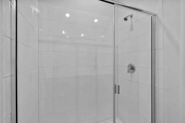 a bathroom with a shower and a glass door
