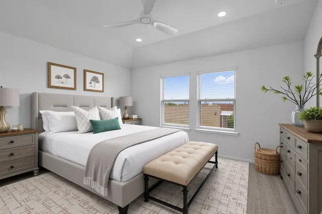 a bedroom with bed and a potted plant