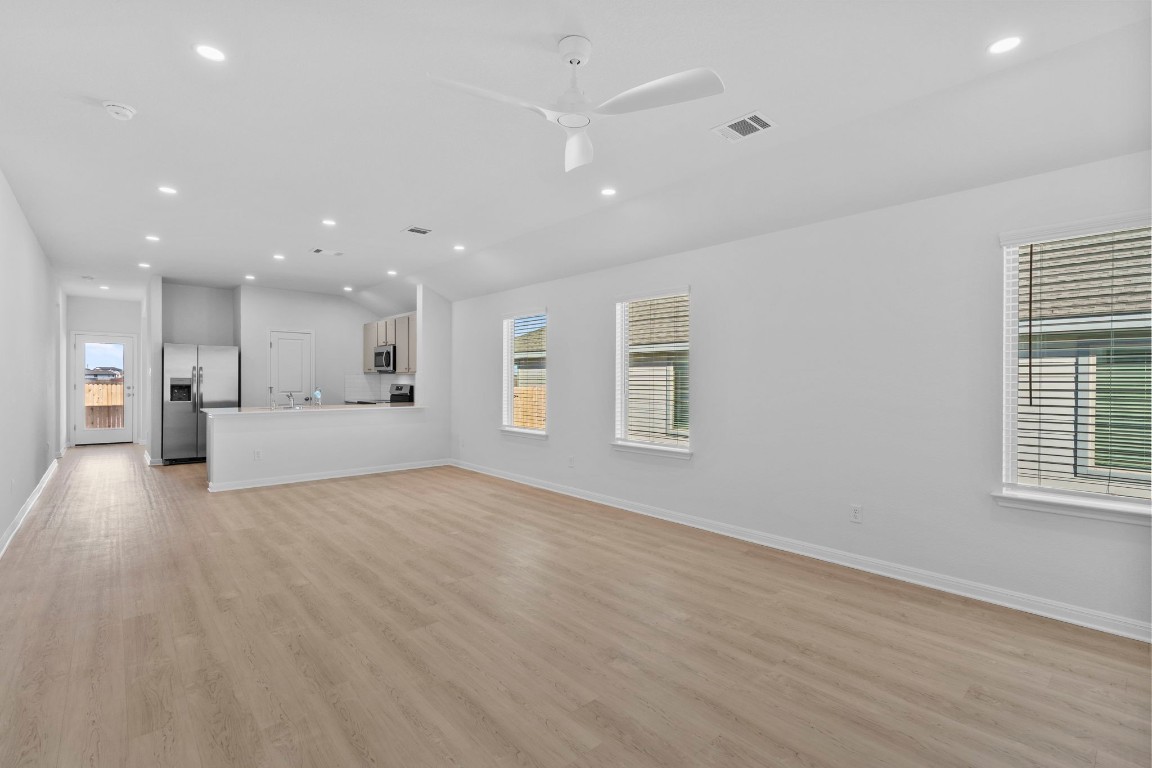 129 Hatari Trail Jarrell, TX 76537 - Photo 8 of 33 a view of an empty room with a window and wooden floor