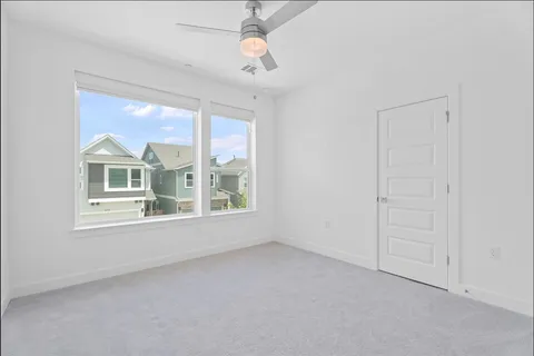 a bedroom with bed and a window