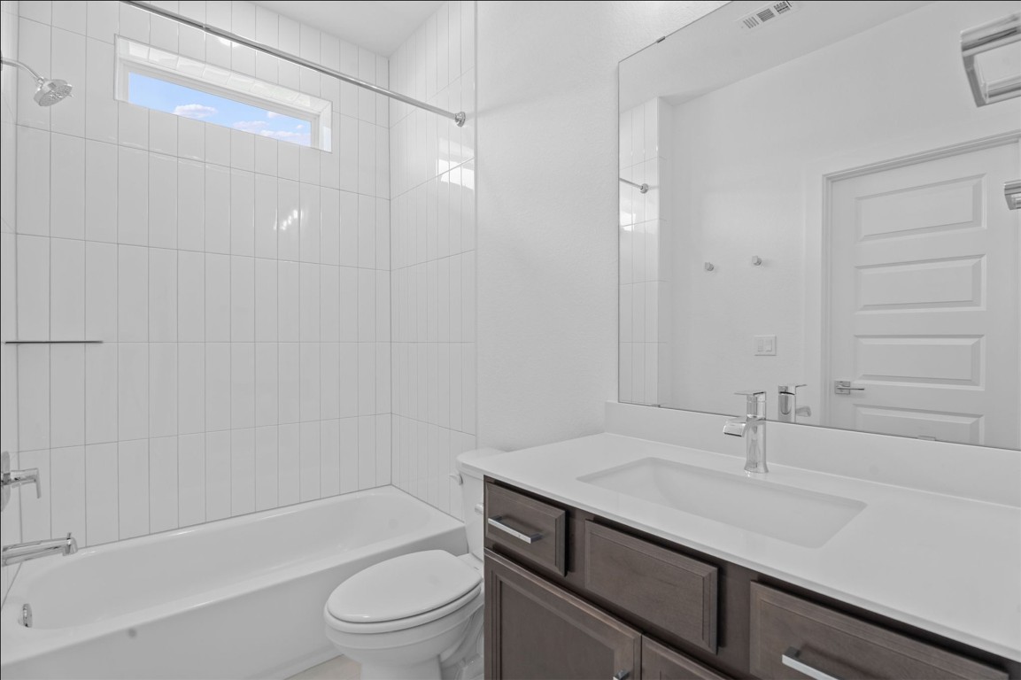 609 Terrier Trail Austin, TX 78745 - Photo 13 of 26 a bathroom with a sink a toilet and shower