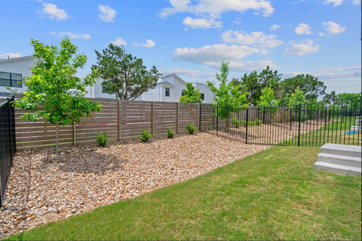 609 Terrier Trail Austin, TX 78745 - Photo 15 of 26 a view of a yard with a wooden fence