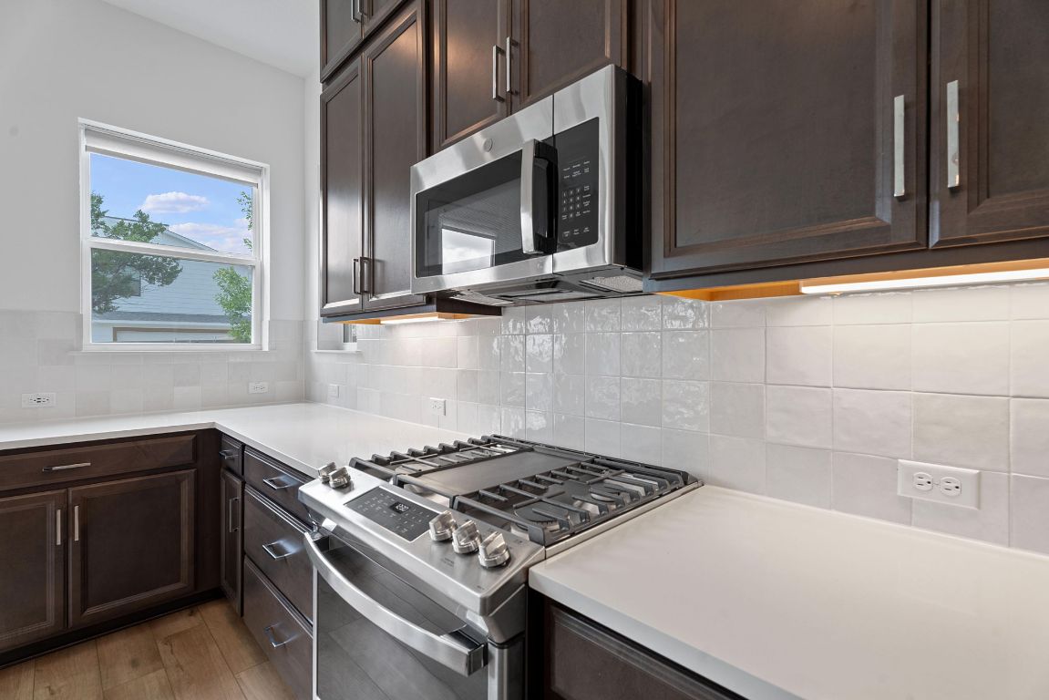 609 Terrier Trail Austin, TX 78745 - Photo 2 of 26 a stove top oven sitting inside of a kitchen