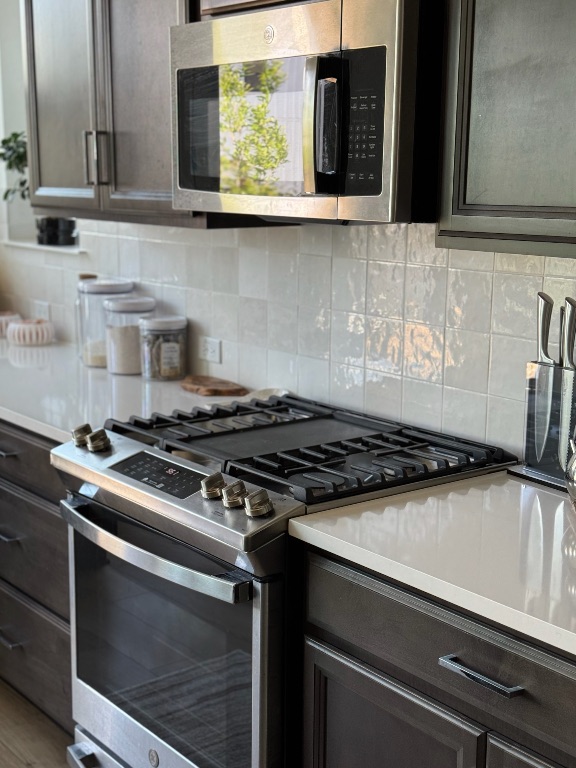 609 Terrier Trail Austin, TX 78745 - Photo 3 of 26 a stove top oven sitting inside of a kitchen