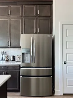 a stove top oven sitting inside of a kitchen