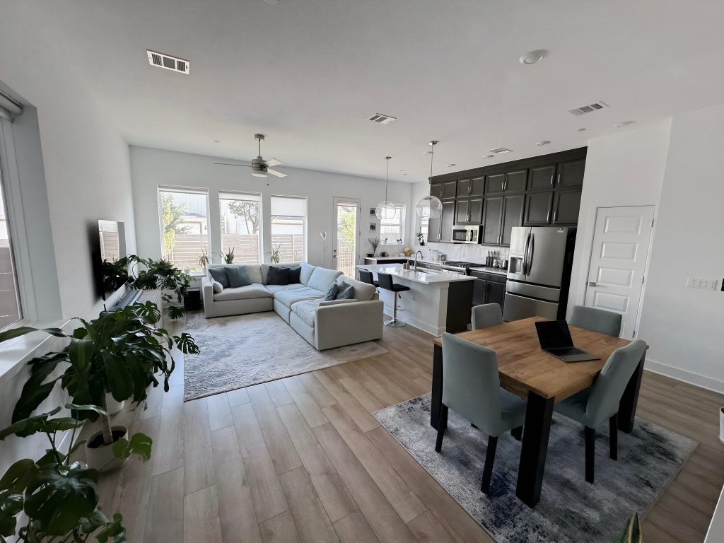 609 Terrier Trail Austin, TX 78745 - Photo 5 of 26 a living room with furniture potted plant wooden floor and a window