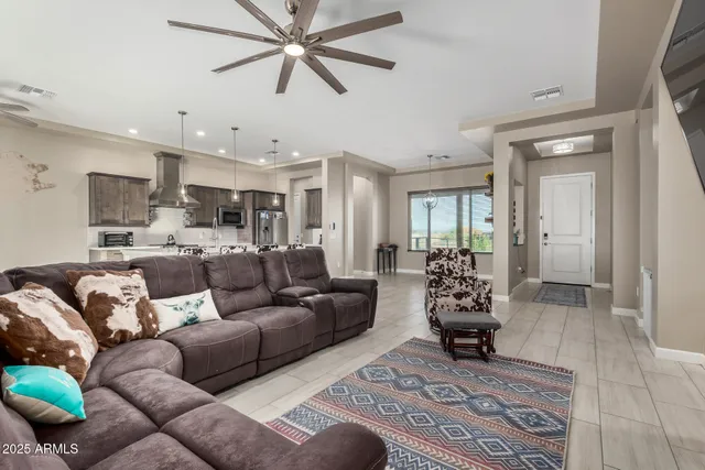 a living room with furniture and a view of kitchen
