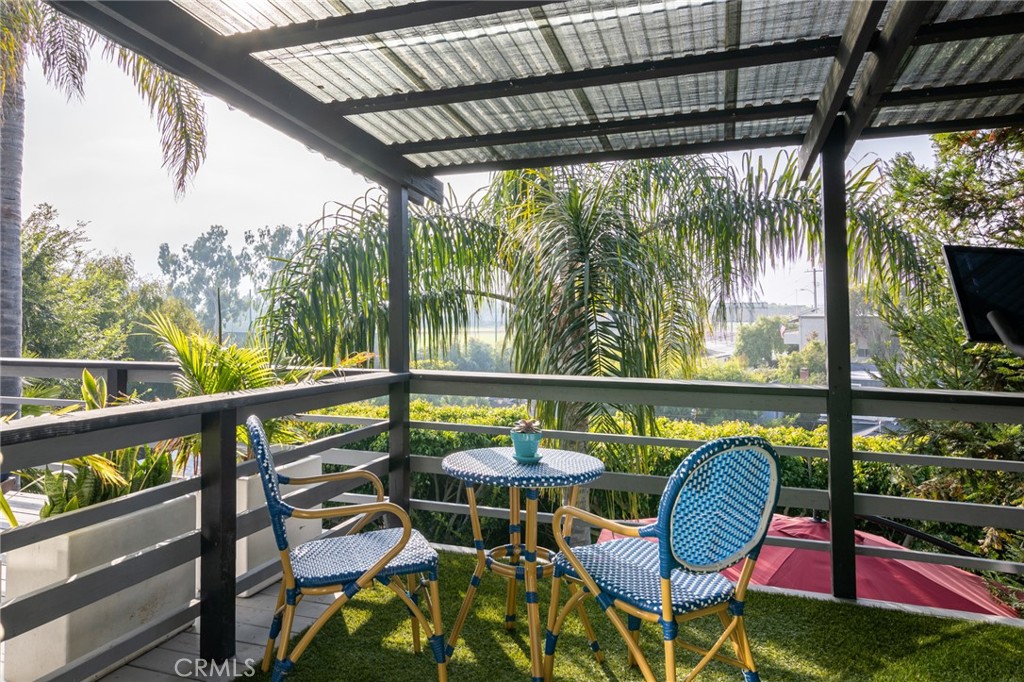736 Griffith Place Laguna Beach, CA 92651 - Photo 16 of 24 a view of a chairs and table in patio with wooden fence