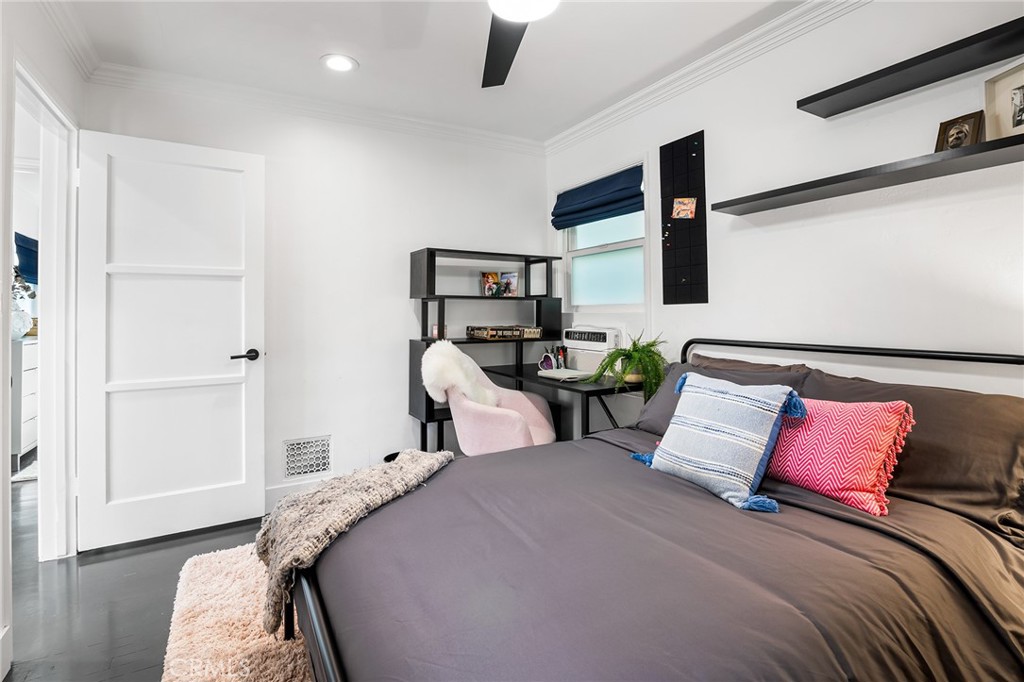 736 Griffith Place Laguna Beach, CA 92651 - Photo 19 of 24 a bedroom with a bed a flat screen tv and view of kitchen