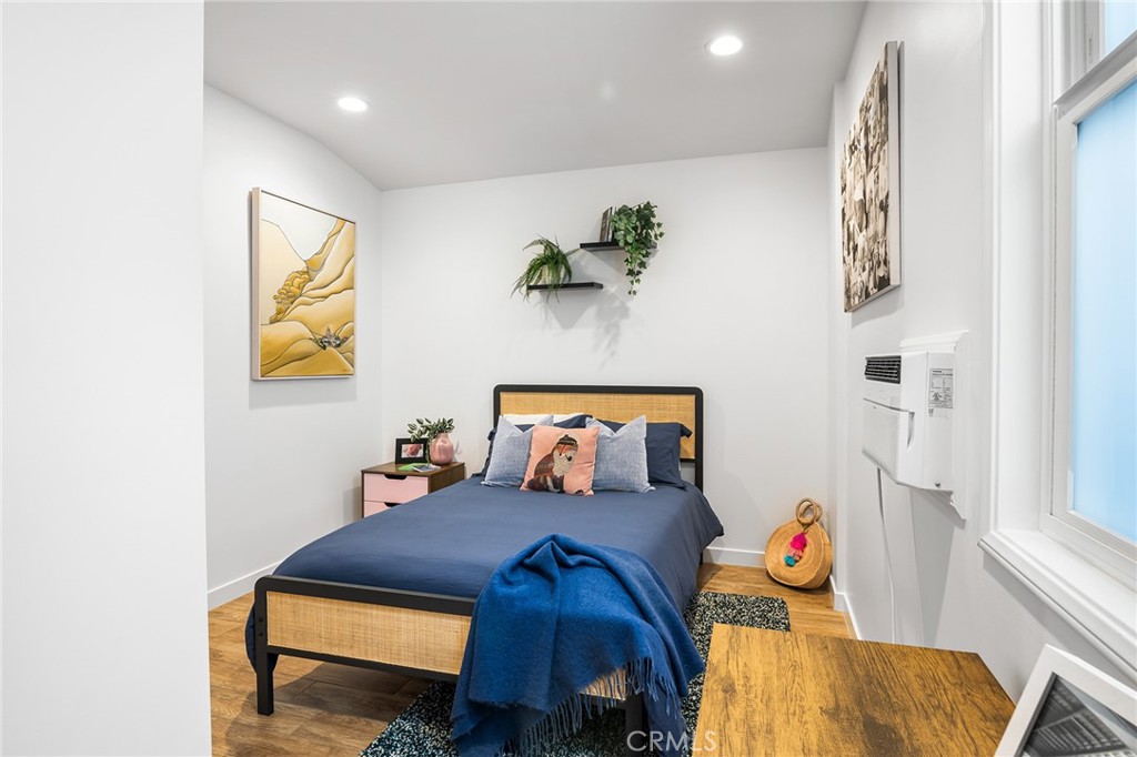 736 Griffith Place Laguna Beach, CA 92651 - Photo 22 of 24 a bedroom with a bed and wooden floor